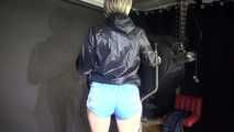 Watching sexy SONJA wearing a sexy blue shiny nylon shorts and a rainjacket during her workout on the hometrainer (Video)