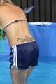 Watch Sandra cleaning the pool wearing a shiny nylon Shorts