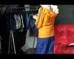 Lucy wearing a sexy blue shiny nylon pants and an orange rain jacket while folding clothes (Video)