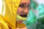 Jill tied, gagged and hooded on a stairway wearing a sexy shiny yellow rainwear combination (Pics)