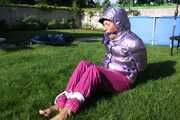 Watch Sandra beeing bound and gagged in her shiny nylon Downwear in the Garden