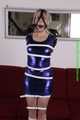 Sophie bound with Leatherbelts and Harnessgagged wearing a shiny purple Dress