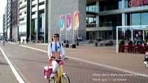I’m cycling through Amsterdam in my mini school uniform