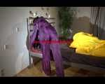 Lucy wearing a purple rain suit preparing her bed cloths for enjoying herself and the rain suit in bed lolling around (Video)