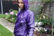 Watching sexy Aiyana wearing a sexy purple shiny nylon shorts and a purple shiny nylon rain jacket enjoying the garden shower (Pics)