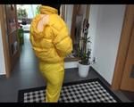 Jill wearing a yellow rain pants down jacket combination and rubber boots at home and outdoor (Video)