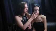 Two girls smoking from each others hands