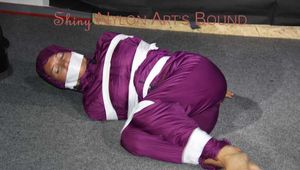 Sexy Sandra being tied, gagged and hooded with tape on the floor wearing a supersexy purple rain overall (Pics)