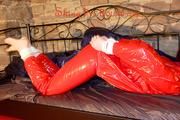 Mara tied and gagged on a princess bed in an old cellar wearing a sexy red sauna suit (Pics)