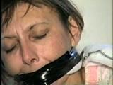 48 Yr OLD WAITRESS IS BALL-GAGGED, CLEAVE & WRAP TAPE GAGGED, BOUND HANDS, WRIST-GAGGED, MOUTH STUFFED & HANDGAGGED (D41-10)