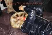Sexy Sandra wearing a sexy shiny black rain pants and a sexy black down jacket with coat ties, gagges and hoodes herself on a bed with shiny nylon linen (Pics)