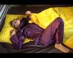 Lucy wearing a purple rain suit preparing her bed cloths for enjoying herself and the rain suit in bed lolling around (Video)