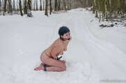 Naked barefoot brunette chained in the snow