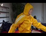 Sonja wearing a hot very small blue shiny nylon shorts and a yellow rain jacket while preparing her bed (Video)