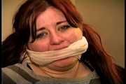 23 YR OLD REAL ESTATE BROKER IS WRAP BONDAGE TAPE GAGGED, MOUTH STUFFED, CLEAVE GAGGED, HANDGAGGED, BANDANNA GAGGED, GAGS ON A SPONGE, GAG-TALKING, NYLON COVERED BARE FEET AND TIED TO A CHAIR (D75-14)