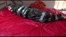 Mara taped, gagged and hooded on bed wearing a sexy shiny camouflage rainwear (Video)