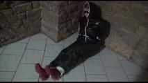 Jill tied, gagged and hooded on a cellar floor wearing a shiny green rain pants and a shiny black down jacket (Video)