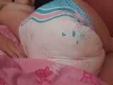 Video and pics - sensual images of Emma waking up in a very wet diaper