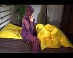 Lucy wearing a purple rain suit preparing her bed cloths for enjoying herself and the rain suit in bed lolling around (Video)