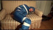 Mara tied, gagged and hooded on a sofa wearing a sexy blue shiny nylon down skibib (Video)