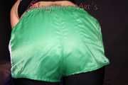 Watching sexy Sandra wearing a sexy black cycling shorts, a top and a sexy green shiny nylon shorts while preparing her bed (Pics)