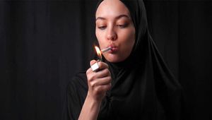 Ksenia is smoking two cigs wearing hijab