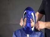 Watch Sandra beeing bound, pantygagged and finally pantyhooded in her shiny nylon Rainwear