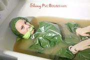 Mara ties, gagges and hoodes herself with cuffs and a gag sitting in a bath tub full of muddy water wearing a sexy green catsuit with hood (Pics)