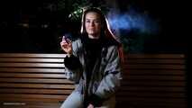Mature woman smoking outdoors