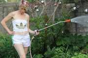 Watching sexy Sonja wearing white shiny nylon shorts and a top during watering the garden (Pisc)