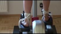 Pia tied and gagged on a crosstrainer for doing her workout well wearing a hot shiny nylon shorts and a rain jacket (Video)