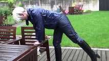 Watching sexy Courtney feeling comfortable in her dark blue  shiny nylon rainwear cleaning the table outside (Video)