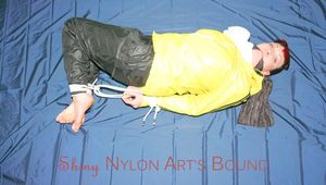 Jill tied and gagged on bed wearing a sexy black shiny nylon rain pants and a yellow and a white shiny nylon rain jacket (Pics)