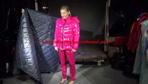Sexy Sandra wearing sexy shiny nylon pink rain pants and a sexy shiny nylon down jacket being wrapped in a down cover tied and gagged with tape and a clothgag (Video)