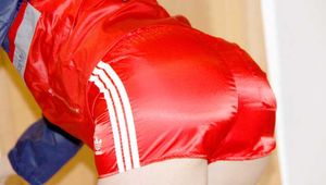 SONJA wearing a sexy red shiny nylon shorts and a red/blue rain jacket cleaning up the flat (Pics)