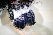 Sonja taking a bath wearing a sexy black shiny nylon shorts and a rain jacket playing with the foam and the water as well as her clothes (Pics)