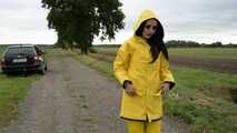 Miss Amira on the road in a Frisian mink, yellow rain dungarees and rubber boots