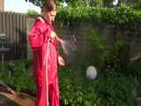 Watch Sandra watering the garden and wetting her shiny nylon oldschool Rainsuit in the Pool