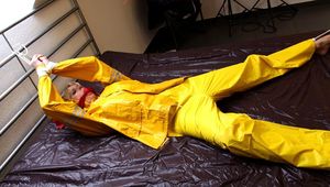 Pia tied and gagged in a shiny nylon rainsuit 