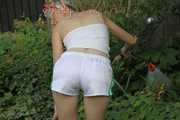 Watching sexy Sonja wearing white shiny nylon shorts and a top during watering the garden (Pisc)