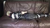 ***NEW MODELL COURTNEY*** wearing a sexy black shiny nylon rain pant and a a black rain jacket being tied and gagged with tape and a ballgag on a sofa (Video)