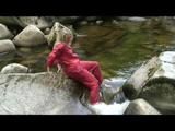Sophie enjoying the water and weather on a river wearing supersexy red rainwear (Video)