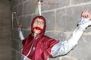 Nicole tied and gagged by Sophie in an red/silver PVC rainsuit in the cellar
