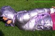 Watch Sandra beeing bound and gagged in her shiny nylon Downwear in the Garden