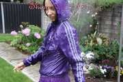 Watching sexy Aiyana wearing a sexy purple shiny nylon shorts and a purple shiny nylon rain jacket enjoying the garden shower (Pics)