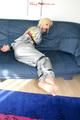 Blond-haired maid tied and gagged with tape wearing a shiny silver PVC sauna suit (Pics)