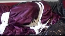 Lucy tied, gagged and hooded on the sofa wearing a sexy purple shiny nylon downwear combination (Video)