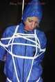 Watching sexy Pia being tied and gagged overhead with ropes and a ballgag wearing a supersexy blue shiny nylon bib overall and a rain jacket (Pics)