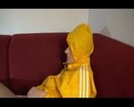 Lucy wearing a rare yellow shiny nylon shorts and a yellow rain jacket while watching TV and lolling on the sofa (Video)