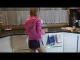 Watching our sexy archive girl wearing a sexy blue shiny nylon shorts and a pink rainjacket doing her housework (Video)